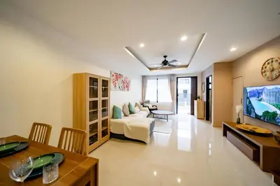 a living room with a couch and a table at Townhouse in the very center of Laguna, 600 m from Bang Tao in Phuket