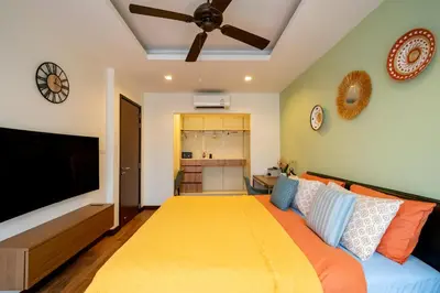 a living room with a couch and a flat screen tv at Townhouse in the very center of Laguna, 600 m from Bang Tao in Phuket