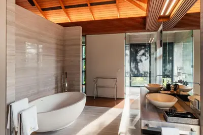 a bathroom with a large tub and two sinks at Villa Princess Maria in Kata Beach
