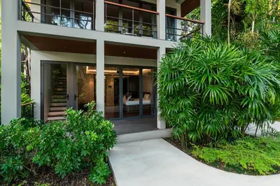 a house with glass doors and plants at Villa Princess Maria in Kata Beach