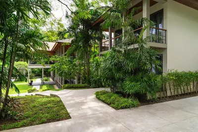 a walkway in front of a building with trees at Villa Princess Maria in Kata Beach