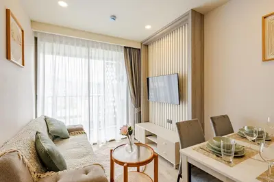 a living room with a couch and a table at The Ozone Condominium 513 One-Bedroom Apartment in Laguna Phuket