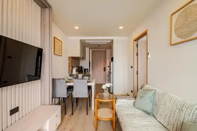 a living room with a couch and a table at The Ozone Condominium 513 One-Bedroom Apartment in Laguna Phuket