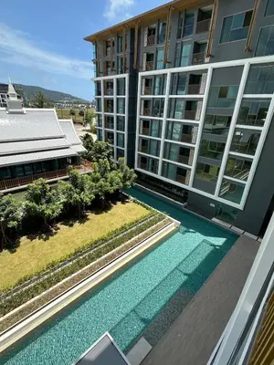 an aerial view of a building with a swimming pool at The Ozone Condominium 513 One-Bedroom Apartment in Laguna Phuket