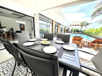 a dining room with a table and chairs at Villa Anthoni - Cozy 3 bedrooms with pool in Rawai Beach