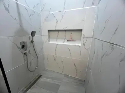 a bathroom with a shower with a candle in a niche at Villa Anthoni - Cozy 3 bedrooms with pool in Rawai Beach