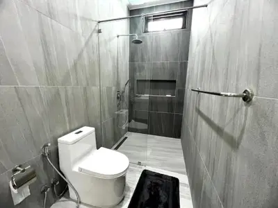 a small bathroom with a toilet and a shower at Villa Anthoni - Cozy 3 bedrooms with pool in Rawai Beach