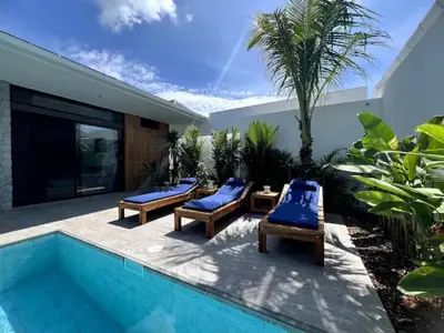 a patio with chaise lounge chairs and a swimming pool at Villa Anthoni - Cozy 3 bedrooms with pool in Rawai Beach