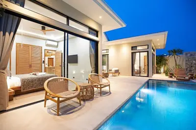 a villa with a swimming pool and a bedroom at Villa Chang Thai - Stylish 3 Bedrooms with Private Pool in Rawai Beach