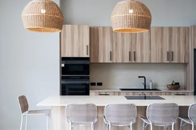 a kitchen with a white counter and some chairs at Villa Chang Thai - Stylish 3 Bedrooms with Private Pool in Rawai Beach