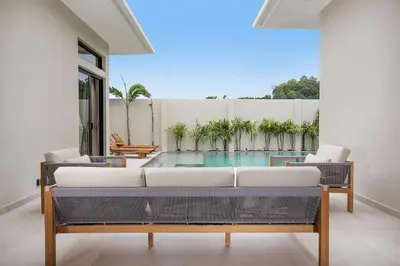 a living room with a couch and a pool at Villa Chang Thai - Stylish 3 Bedrooms with Private Pool in Rawai Beach