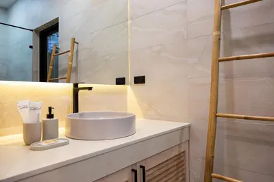 a bathroom with a sink and a mirror at Villa Chang Thai - Stylish 3 Bedrooms with Private Pool in Rawai Beach