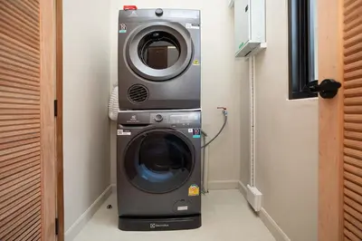 a washing machine and a dryer in a room at Villa Chang Thai - Stylish 3 Bedrooms with Private Pool in Rawai Beach