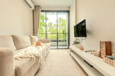 a living room with a couch and a tv at ZcapeX2 94-17 by SilqStay in Bang Tao Beach