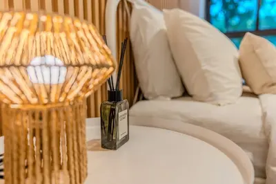 a vase sitting on a table next to a couch at ZcapeX2 94-17 by SilqStay in Bang Tao Beach