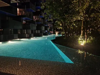 an empty swimming pool at night with lights at The Deck Patong Pool View in Patong Beach