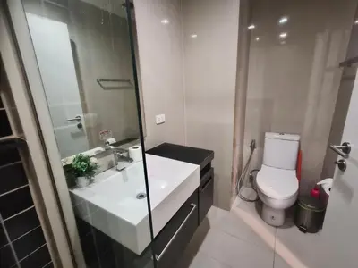 a bathroom with a white sink and a toilet at The Deck Patong Pool View in Patong Beach