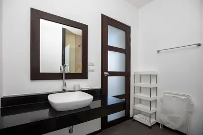 a bathroom with a sink and a mirror at Villa Dinadi - Superb 2 Bedrooms Pool Villa in Rawai Beach