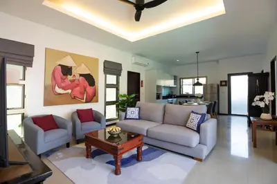 a living room with a couch and a table at Villa Dinadi - Superb 2 Bedrooms Pool Villa in Rawai Beach