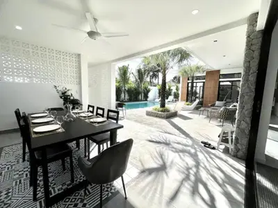 a dining room with a table and chairs and a pool at Villa Lola - Modern 3 Bedrooms Villa with Pool in Ban Saiyuan (1)