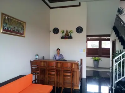 a man sitting at a bar in a restaurant at David Residence in Nai Yang Beach