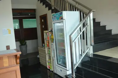a refrigerator in a room with a staircase at David Residence in Nai Yang Beach