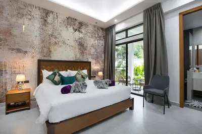 a bedroom with a large white bed in a room at Villa Matara - Large & Stylish 5 Bedrooms with Pool in Rawai Beach