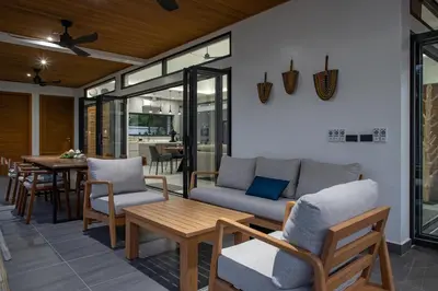 a living room with a couch and chairs and a table at Villa Matara - Large & Stylish 5 Bedrooms with Pool in Rawai Beach