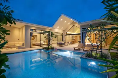 a house with a swimming pool at night at Nomad Villa - Elegant 3 Bedrooms Balinese Pool in Rawai Beach