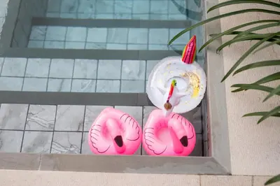 a pair of pink donuts in a box with candles at Nomad Villa - Elegant 3 Bedrooms Balinese Pool in Rawai Beach