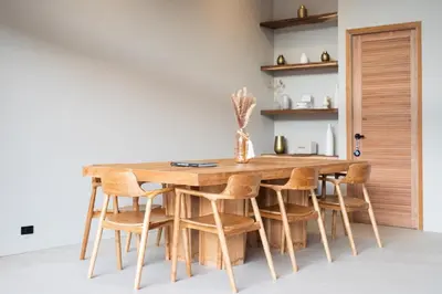 a kitchen with a wooden table and chairs at Nomad Villa - Elegant 3 Bedrooms Balinese Pool in Rawai Beach