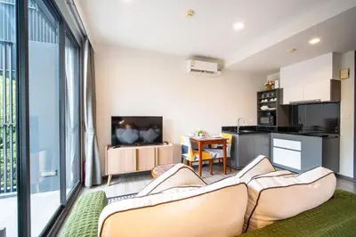 a living room with a couch and a kitchen at \u8d85\u4f18\u60e0 43\u82ad\u4e1c\u6d77\u6ee9\u7cbe\u88c5\u516c\u5bd3 5\u5206\u949f\u6d77\u6ee910\u5206\u949f\u9152\u5427\u8857 \u65c5\u884c\u5ea6\u5047\u9996\u9009 in Patong Beach
