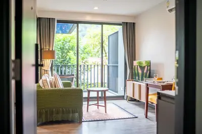 a room with a balcony with a chair and a table at \u8d85\u4f18\u60e0 43\u82ad\u4e1c\u6d77\u6ee9\u7cbe\u88c5\u516c\u5bd3 5\u5206\u949f\u6d77\u6ee910\u5206\u949f\u9152\u5427\u8857 \u65c5\u884c\u5ea6\u5047\u9996\u9009 in Patong Beach
