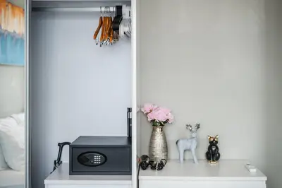 a shelf with a microwave and a vase with flowers at Diamond Resort Phuket walk to Bangtao Beach in Phuket