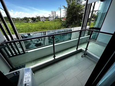 a balcony with a bench and a view of a field at Royal Lee Airport Phuket in Ban Bo Han