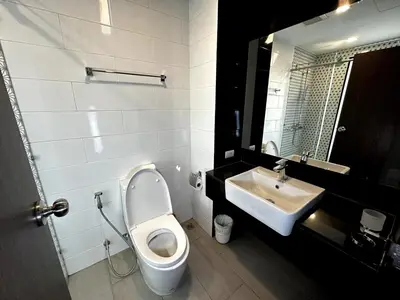 a bathroom with a toilet and a sink at Royal Lee Airport Phuket in Ban Bo Han