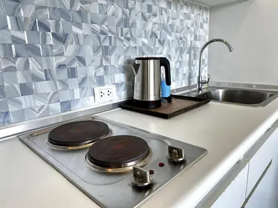 a kitchen stove with two wooden plates on it at Royal Lee Airport Phuket in Ban Bo Han