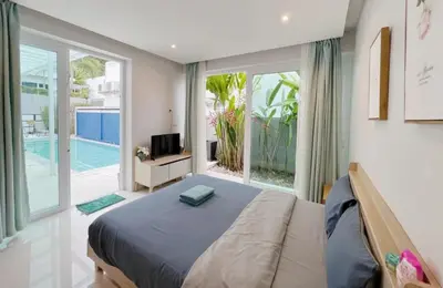 a bedroom with a bed and a large window at 3bedrooms pool Villa in Kamala in Kamala Beach