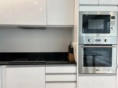 a kitchen with white cabinets and a stainless steel oven at 3bedrooms pool Villa in Kamala in Kamala Beach