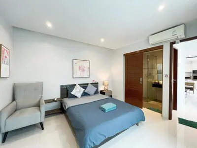 a bedroom with a bed and a chair at 3bedrooms pool Villa in Kamala in Kamala Beach