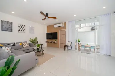 a living room with a couch and a ceiling fan at 7BR Patong pool villa in Patong Beach