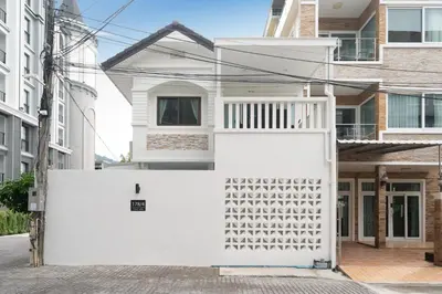 a white fence in front of a house at 7BR Patong pool villa in Patong Beach