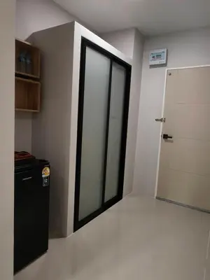 a room with a sliding glass door and a room with a refrigerator at Le Wadee Residence in Bang Tao Beach