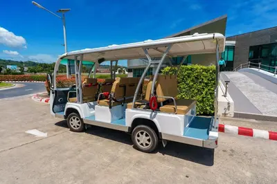 a golf cart parked in front of a building at New 1 Bdr Royal Lee Nayang beach in Ban Bo Han