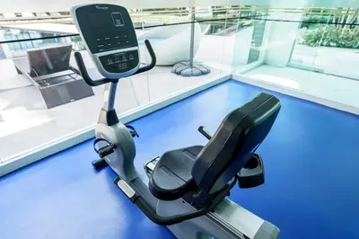 a exercise bike in a gym with a cell phone on it at New 1 Bdr Royal Lee Nayang beach in Ban Bo Han