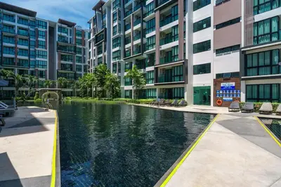 an apartment complex with a pool in front of a building at New 1 Bdr Royal Lee Nayang beach in Ban Bo Han
