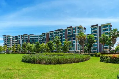 a large apartment building with a park in front at New 1 Bdr Royal Lee Nayang beach in Ban Bo Han