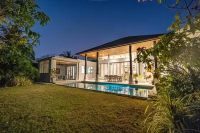 an exterior view of a house with a swimming pool at Botanica 4 BR Villa Layan Beach in Ban Phru Champa