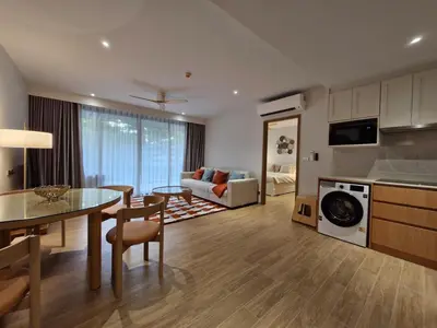 a kitchen and living room with a table and a couch at Laguna Residence, Pool View in Bang Tao Beach