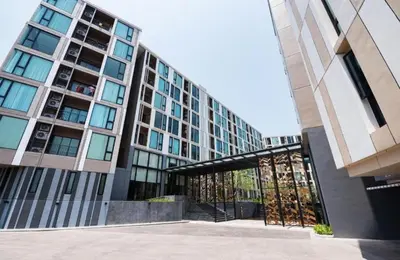 a tall building with a glass door in front of it at ห้องวิวเขา in Ban Ket Ho